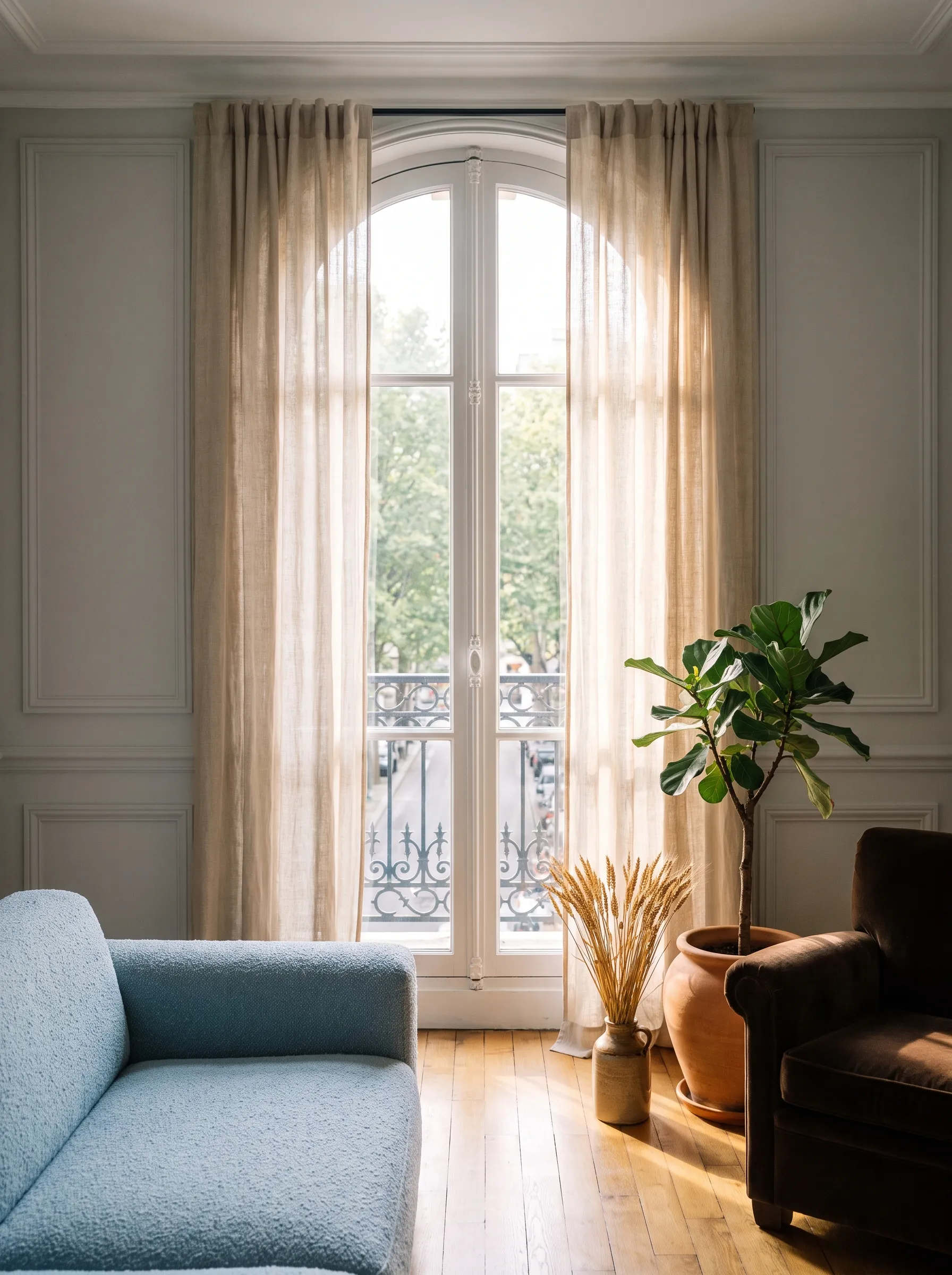Sunlit living room with a tall, freshly cleaned arched window